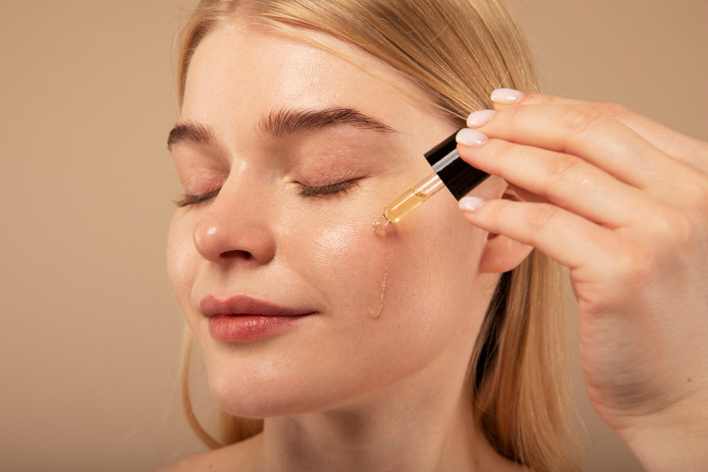 Woman applying organic cleansing oil to her face with a dropper