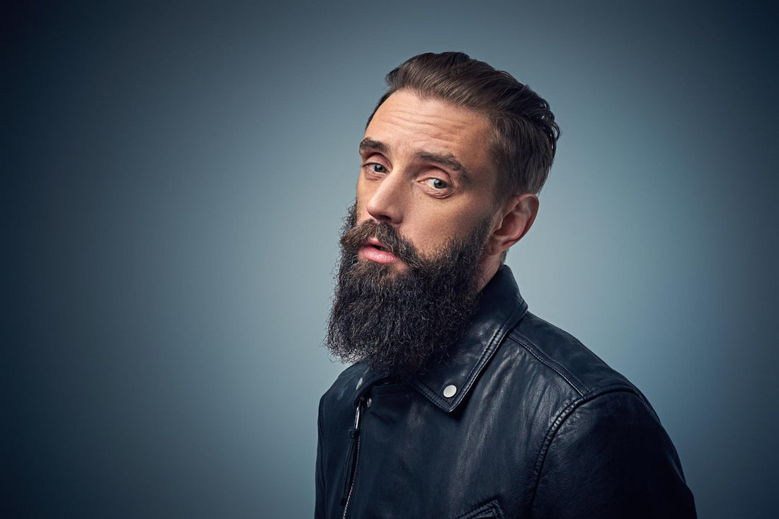 Man with a thick, full beard wearing a leather jacket
