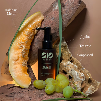 Olio Oil Cleanser bottle with Kalahari Melon, Jojoba, Tea Tree, and Grapeseed text on a natural background.