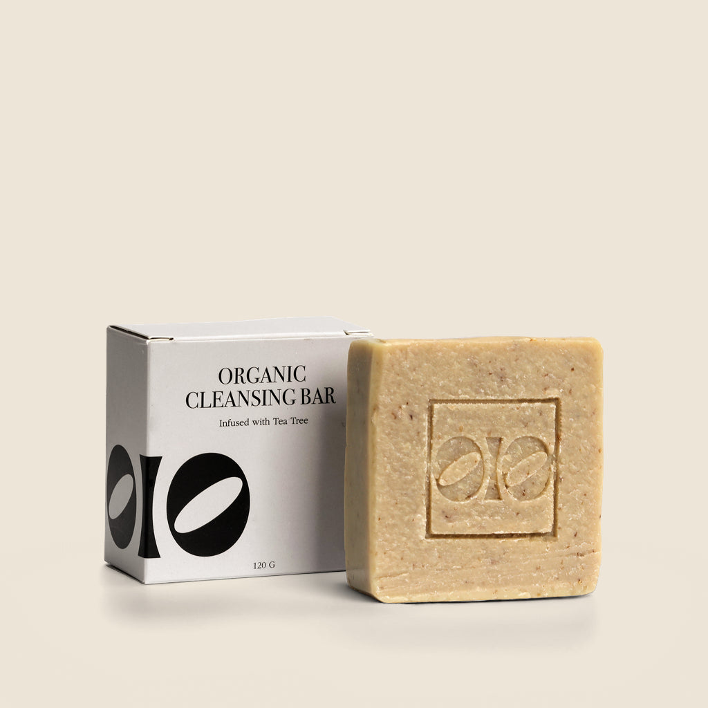 Organic cleansing bar with packaging on a beige background