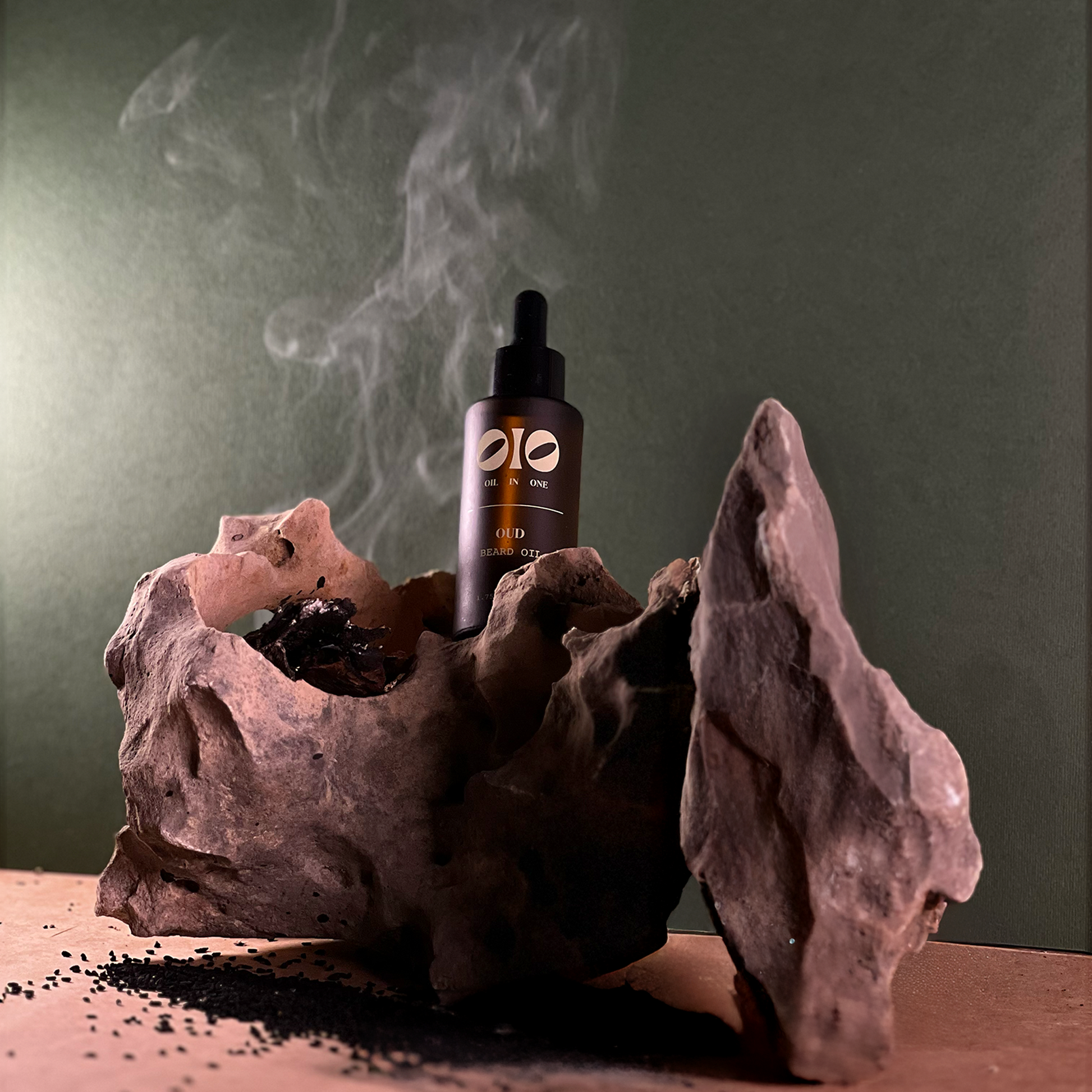 oil dropper in a natural stone holder with smoke on a green background